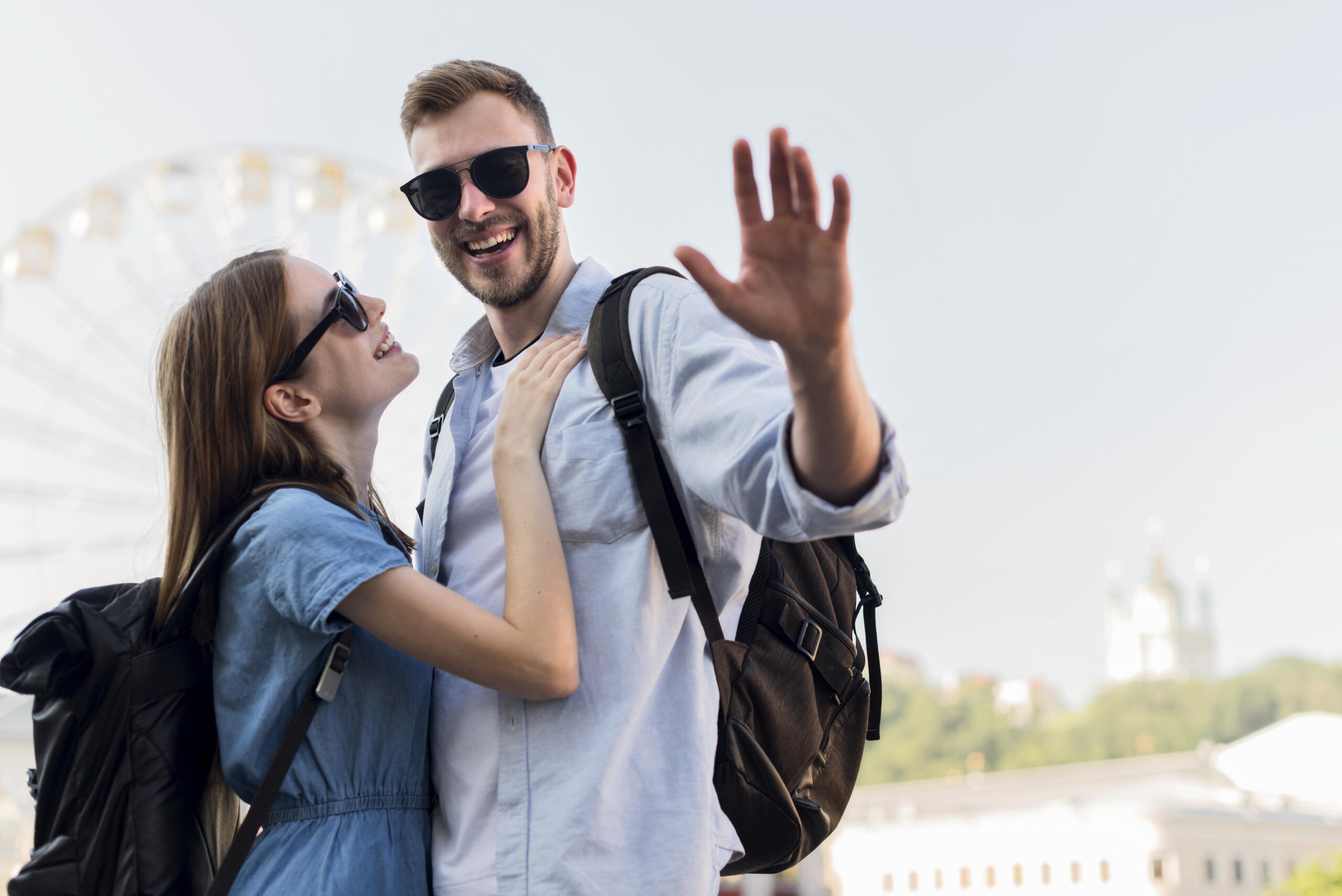 tourist-couple-with-man-waving